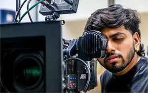 MDFA film student using professional camera equipment at Mumbai Digital Films Academy