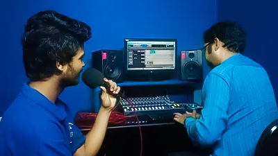 Student recording sound in MDFA studio using Logic Pro X