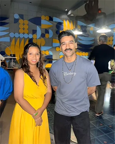 Gitanjali Borah discussing set design with actor Dhanush during production of a Tamil film